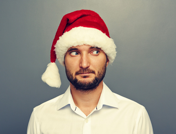 man in santa hat looking at something - Foto, Imagen