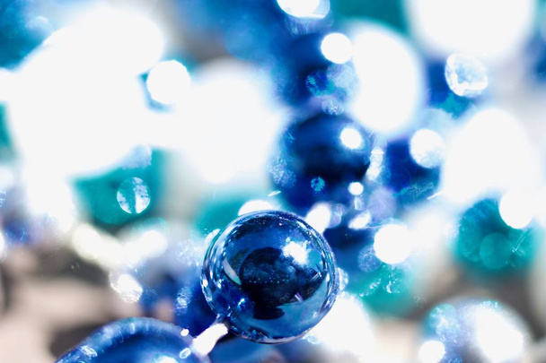 Macro abstract art texture background of defocused multi blue color Mardi Gras beads with bokeh - 写真・画像