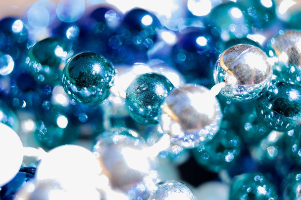 Macro abstract art texture background of defocused multi blue color Mardi Gras beads with bokeh - Photo, image