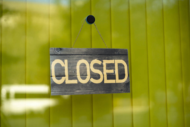 the simple sign board frame hanging on the wall of the building exterior with the word "closed", working hours - Photo, Image