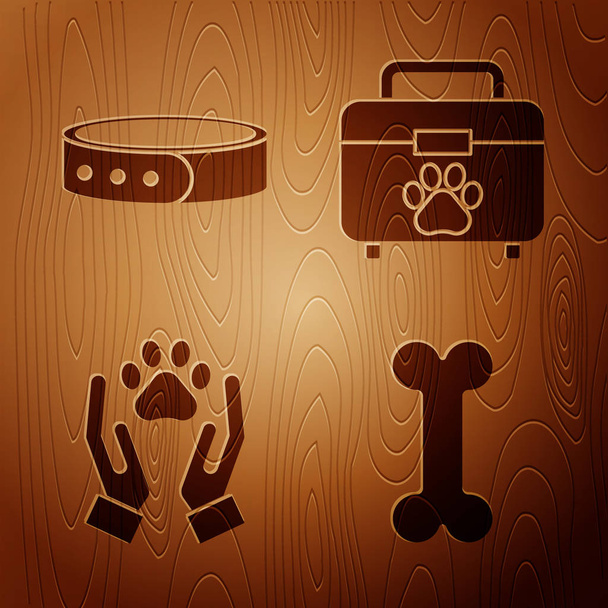Set Hueso de perro, Collar con etiqueta, Manos con huella animal y kit de primeros auxilios para mascotas sobre fondo de madera. Vector
 - Vector, imagen