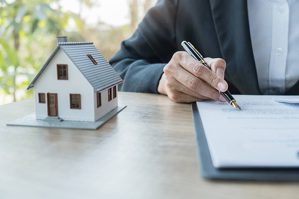 Real estate agent and customer signing contract to buy house, insurance or loan real estate. - Photo, image
