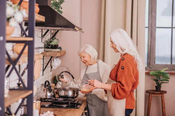 Two elderly women getting the breakfast ready - Valokuva, kuva