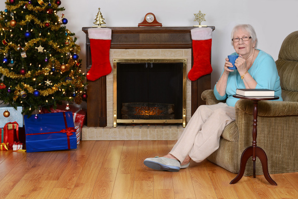Happy senior woman with coffee at christmas - Foto, imagen