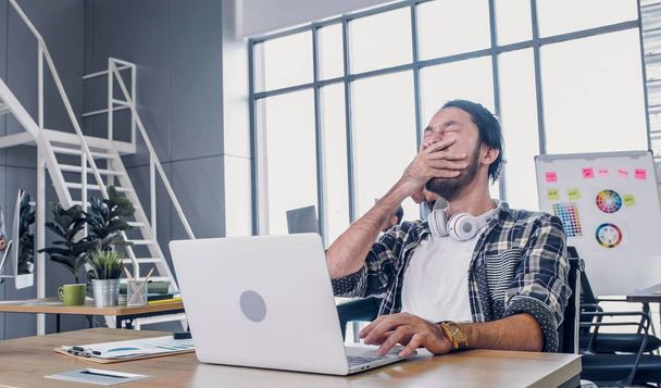 creative designer yawn while working hard and boring with laptop - Fotó, kép
