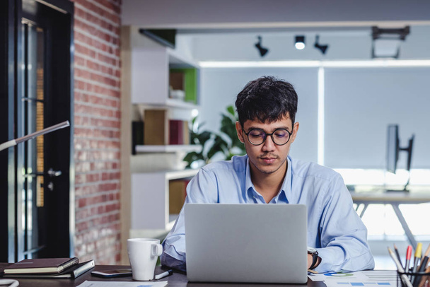 asian businessman woking with laptop and paper work on desk  at  - Fotó, kép