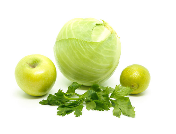 Products for the green diet: cabbage, lime, green Apple and celery on a white background - Foto, afbeelding