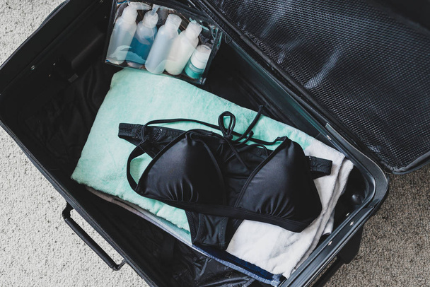 packing light for a holiday concept, luggage with just a  beach  - 写真・画像