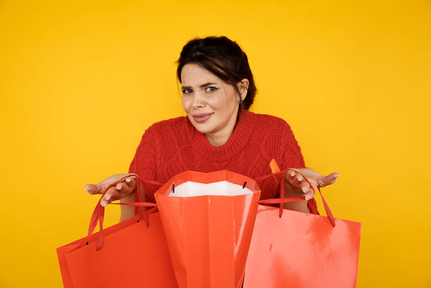 Total sale. Woman holding red shopping bags. - Photo, Image