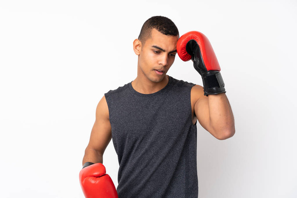 Junger afroamerikanischer Sportler vor isoliertem weißen Hintergrund mit Boxhandschuhen - Foto, Bild