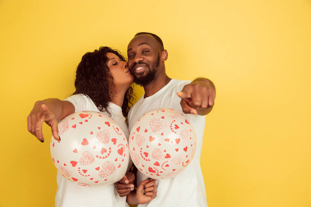 Valentines day celebration, happy african-american couple isolated on yellow background - Valokuva, kuva