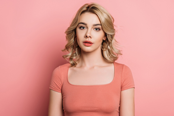 beautiful, dreamy girl looking at camera on pink background - Fotografie, Obrázek