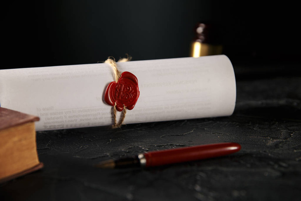 Notary and law concept. Stamp with book and pen on the table. Wooden gavel behind. - Foto, imagen