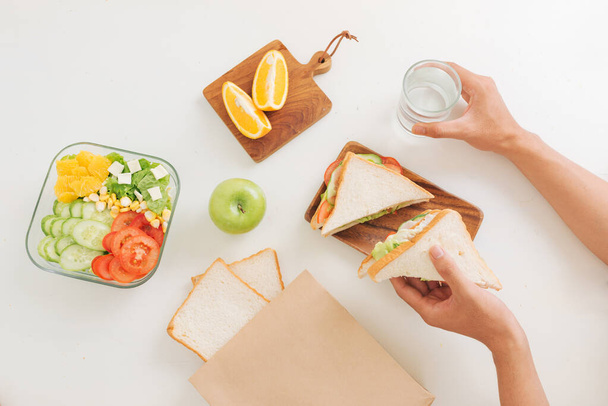 Homemade sandwich breakfast preparing on white table - Фото, изображение