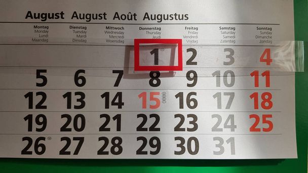 Odessa / Ukraine - 08 01 2019: First of August on wall calendar. Black figure one in red rectangular frame in sunlight with shadow underneath. Numbers in rows on paper sheet of calendar. - Photo, Image