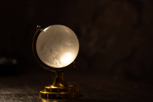 clear glass globe with blurred background on the table - Photo, Image