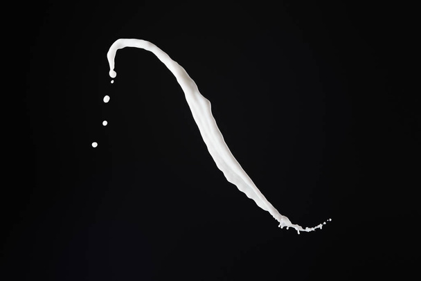 fresh white milk splash with drops isolated on black - Foto, afbeelding