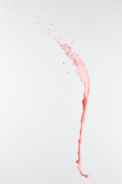 fresh pink milk splash with drops isolated on white - Foto, afbeelding