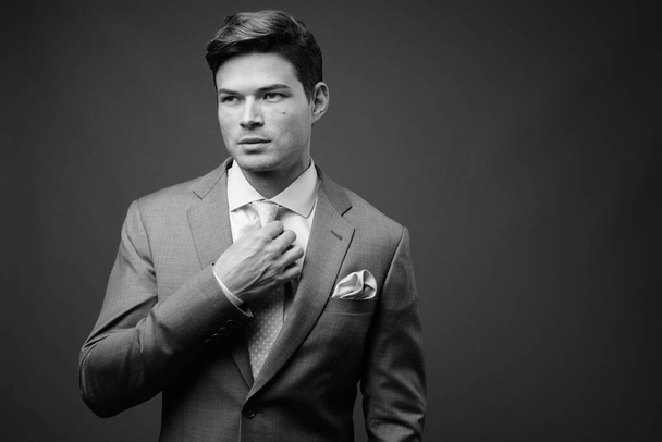 Studio shot of young handsome businessman in suit - Photo, Image