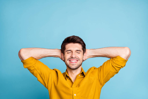 Photo of cheerful attractive guy readying to fall asleep smiling toothily resting relaxing isolated over blue pastel color background - Photo, Image