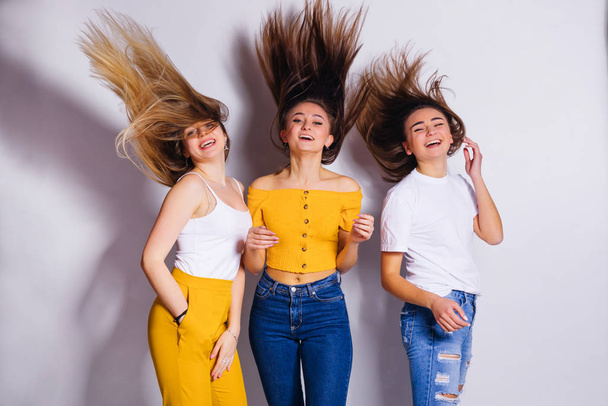 girls in the studio waving their hair. white background. - Photo, image