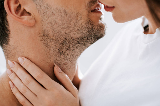 cropped view of woman kissing man at home  - Fotoğraf, Görsel