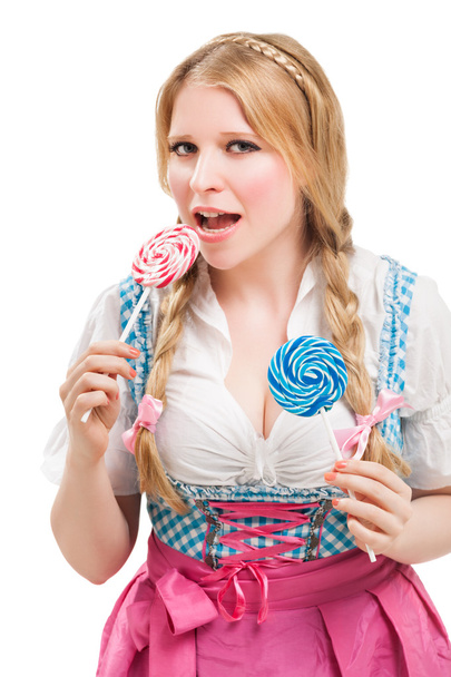 Beierse vrouw in dirndl, met lolly. - Foto, afbeelding