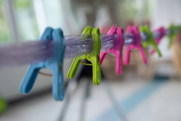 Multi-colored clips on the rope - Foto, Bild