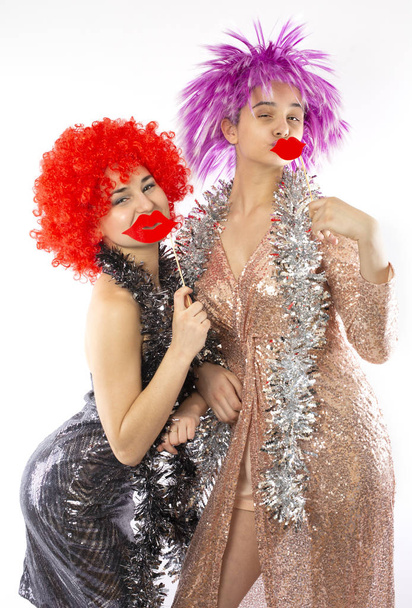 Attractive playful young women ready for carnival parties. Lifestyle and the concept of friendship: a group of two girl friends. - Фото, изображение