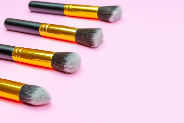 Pink background. Makeup brushes isolated on pink with copy space - Photo, Image