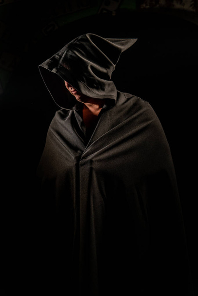 Portrait of a courageous warrior wanderer in a black cloak. Historical fantasy. Halloween. - Zdjęcie, obraz