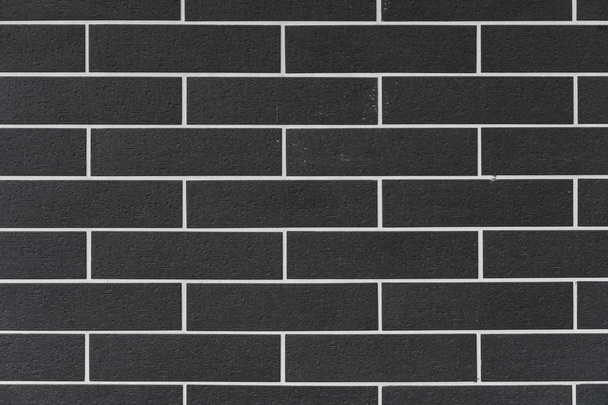 brick wall with black bricks and white filling at square format as background and texture - Foto, immagini