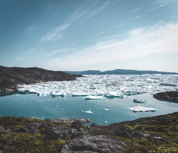 Beautifull landscape with floating icebergs in glacier lagoon and lake in Greenland. Ilulissat Icefjord Glacier. Iceberg and ice from glacier in arctic nature landscape. - Фото, изображение