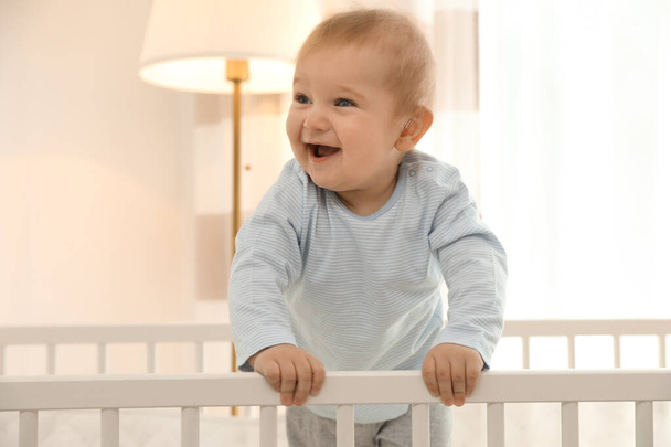 Cute little baby in crib at home - Zdjęcie, obraz