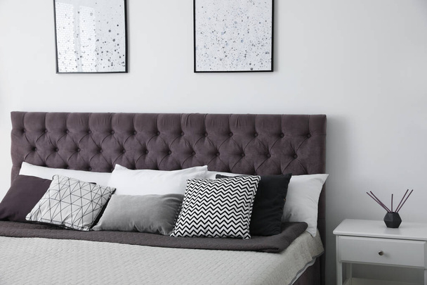 Soft pillows on modern bed in room - Fotografie, Obrázek