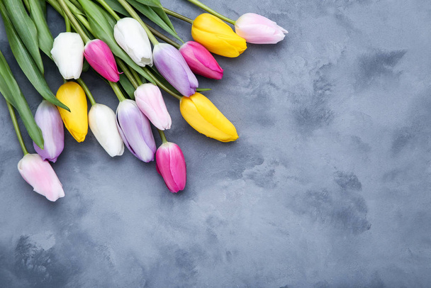 Bouquet of tulip flowers on grey background - Фото, изображение