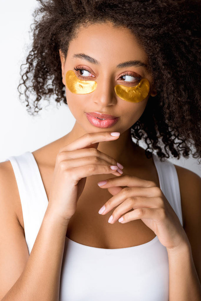 attractive curly african american girl with golden eye patches, isolated on grey - Foto, Bild