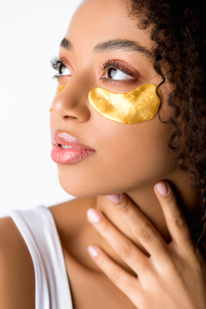 attractive african american girl with golden eye patches, isolated on grey - Fotoğraf, Görsel