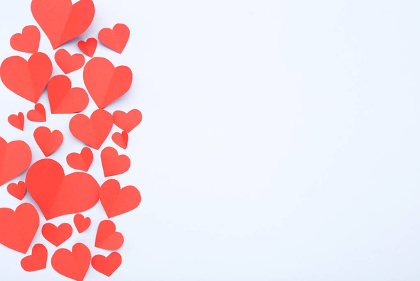 Red paper hearts on grey background - Foto, Imagen