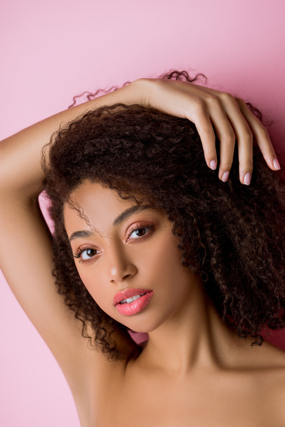 portrait of beautiful curly african american girl, isolated on pink - 写真・画像