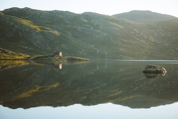 Beautiful view of the reflection of the hills and the sky in a calm lake captured in Norway - Fotografie, Obrázek