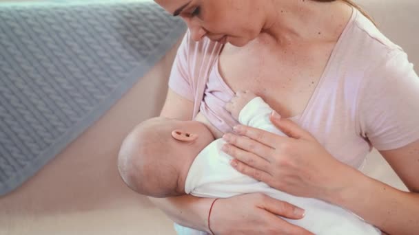 Mother feeding baby at home. Breastfeeding mother with little child - Footage, Video