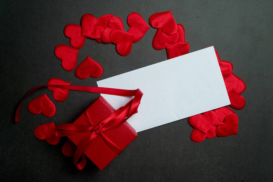 Valentines day,a Declaration of love.White envelope with red hearts. Valentine. On a dark gray background.Gift in a red box. - Fotó, kép
