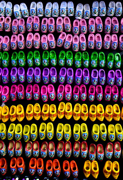 Fridge magnets of little colorful wooden clogs in Amsterdam, Holland, the Netherlands on a black background - Photo, Image