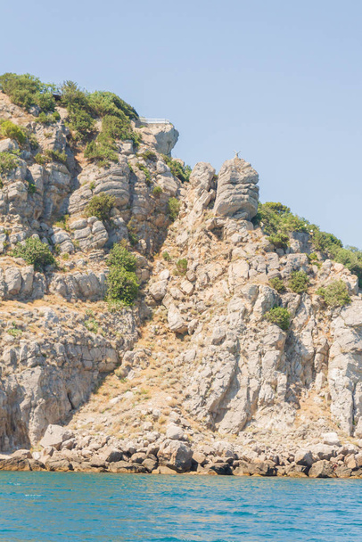 Mountains and rocks on the beach in summer on a Sunny day - Fotó, kép