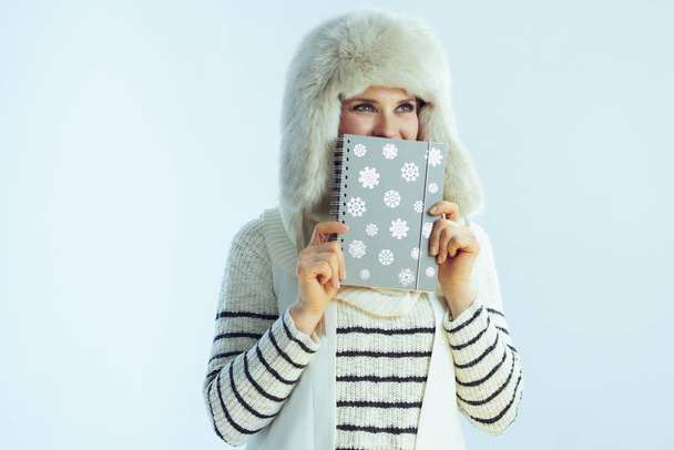 trendy female while hiding behind notebook - Foto, imagen