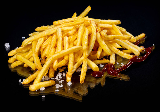 French fries on a black background - Photo, Image