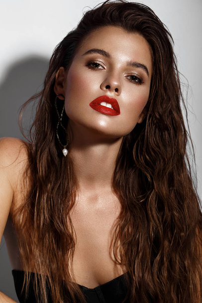 Beautiful sexy girl with bright makeup, red lips, wet hair. Beauty face. - Photo, Image