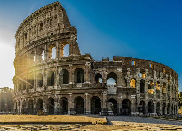 Panoramic view of Colosseum or Coliseum in Rome at sunrise and morning sun, Italy, Europe - 写真・画像