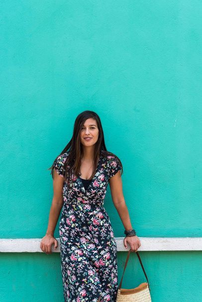 Woman with a summer dress in front of a colorful teal facade in Cholula, Mexico - Foto, Imagem